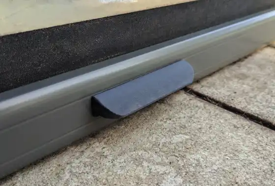 A small 3D printed handle fitted to an aluminium frame